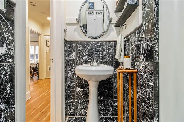 a bathroom with a sink mirror and toilet