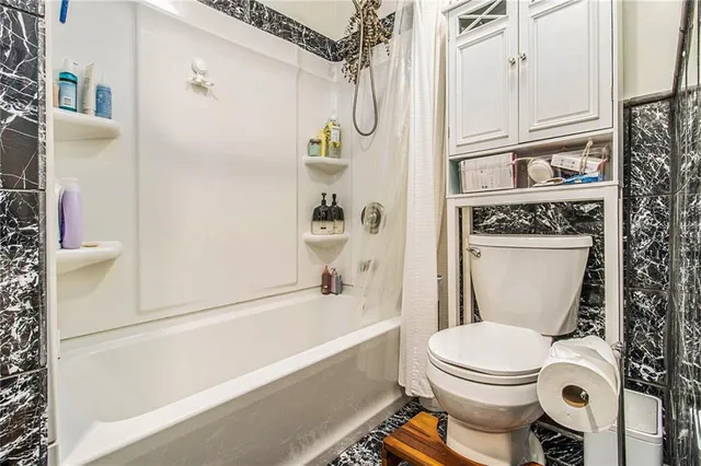 a bathroom with a toilet and a shower