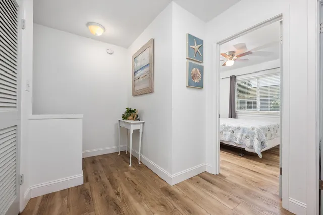 a view of a bedroom with wooden floor and a bedroom