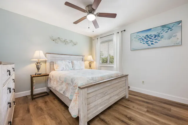 a bedroom with a bed and a ceiling fan