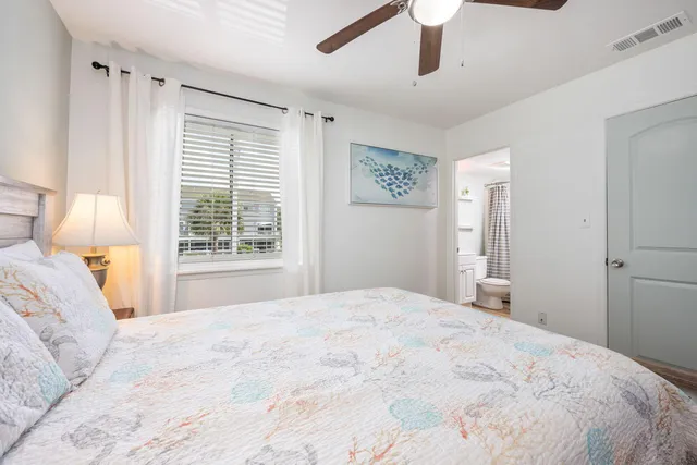 a bedroom with a large bed and a window