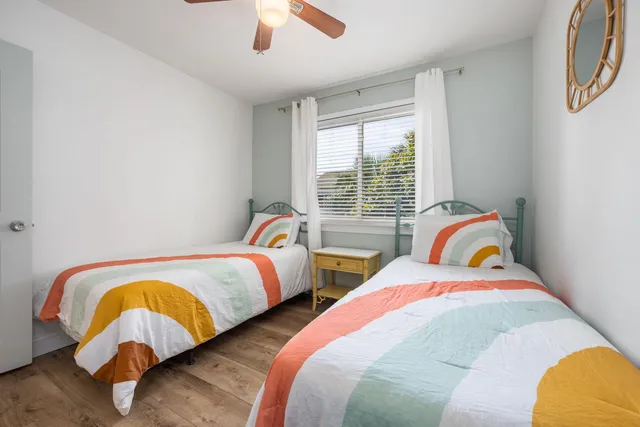 a bedroom with two beds and a window