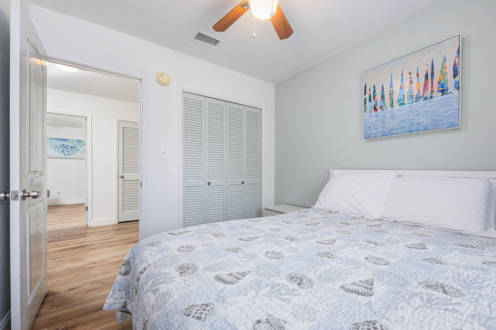 940 Highway 98, Unit 31 Destin, FL 32541 - Photo 28 of 36 a bedroom with a large bed and a chandelier