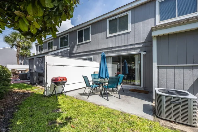 a view of a house with backyard sitting area and garden