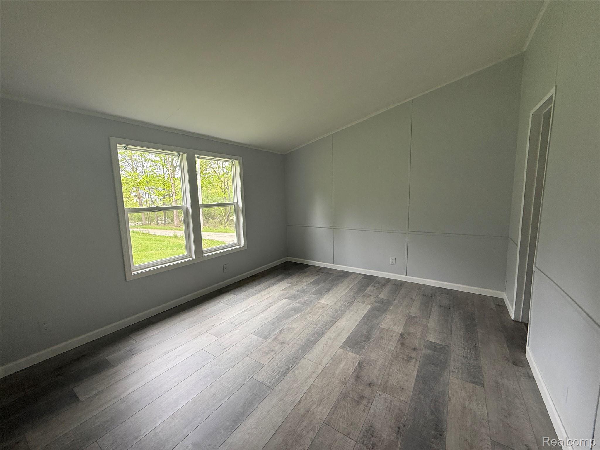 7149-7163 Burpee Road Grand Blanc, MI 48439 - Photo 38 of 72 Empty room featuring vaulted ceiling and light wood-type flooring