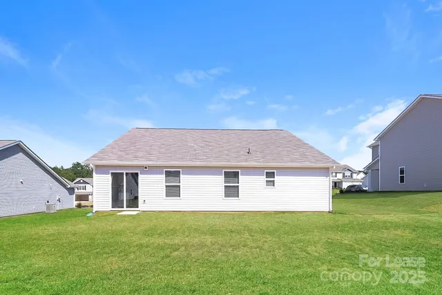 a view of a house with a backyard