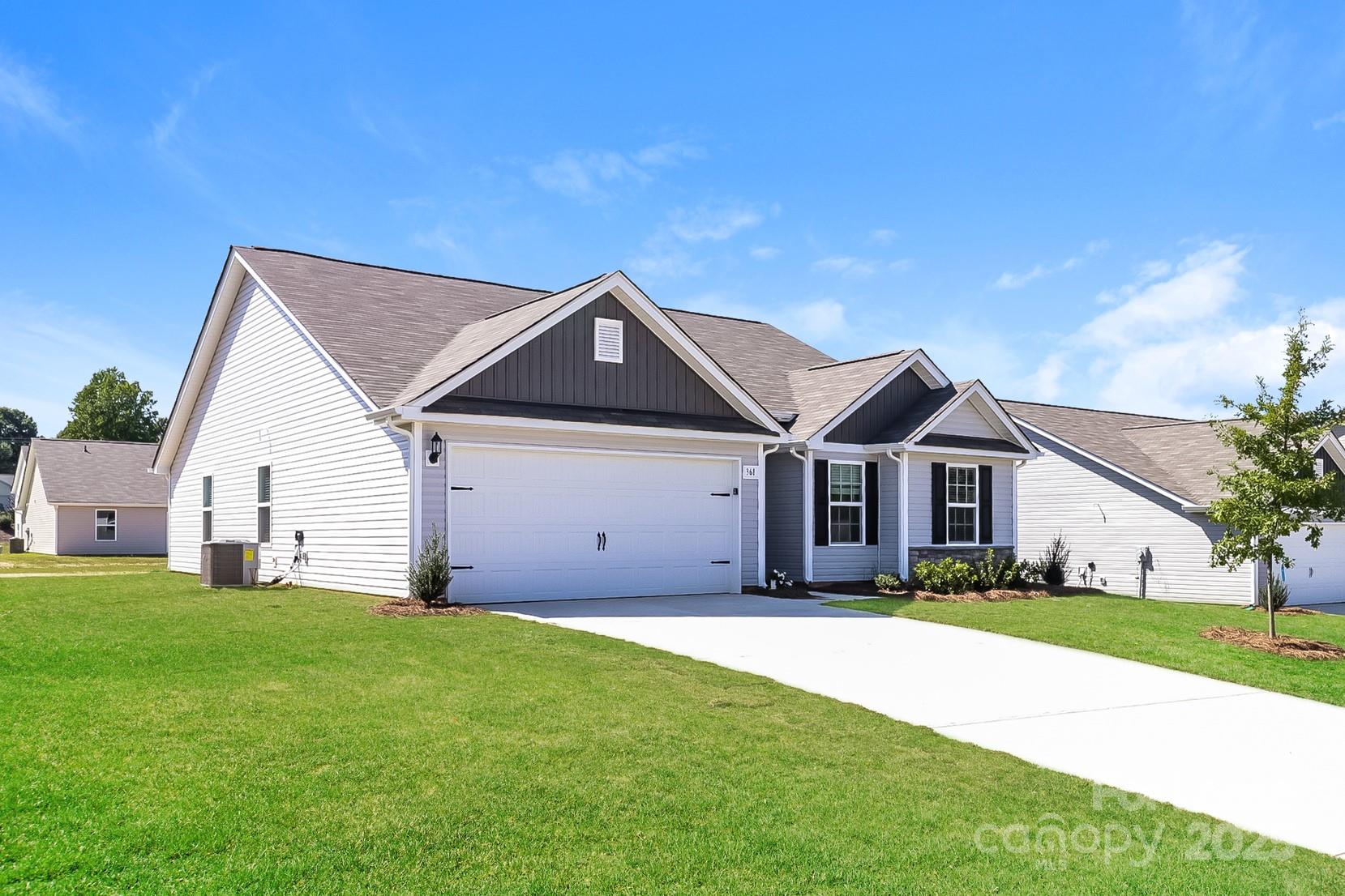 361 Kenyon Drive Kings Mountain, NC 28086 - Photo 2 of 16 a front view of a house with a yard and garage