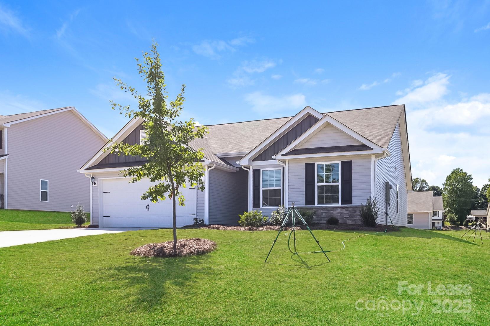 361 Kenyon Drive Kings Mountain, NC 28086 - Photo 3 of 16 a front view of a house with a yard and garage