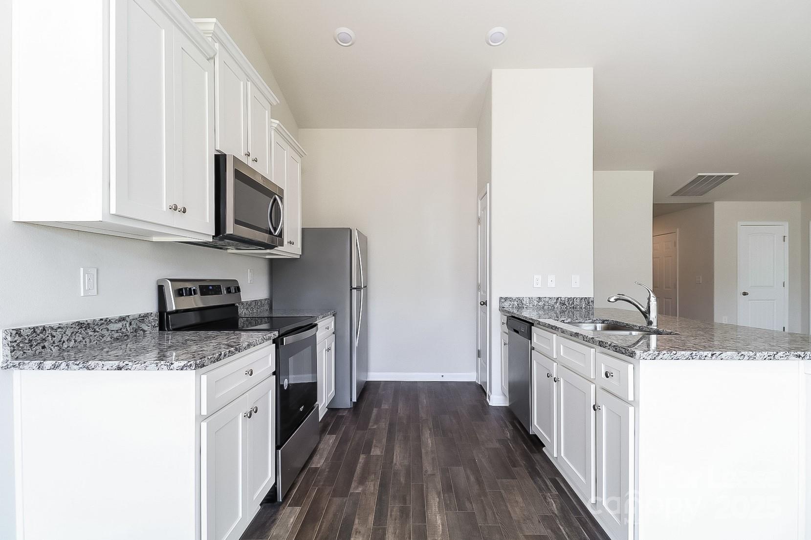 361 Kenyon Drive Kings Mountain, NC 28086 - Photo 4 of 16 a kitchen with stainless steel appliances granite countertop a stove top oven a sink dishwasher and wooden cabinets with wooden floor