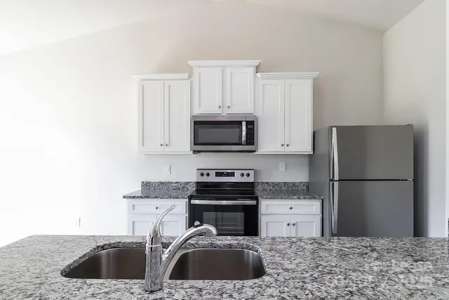 a kitchen with a sink stove and refrigerator