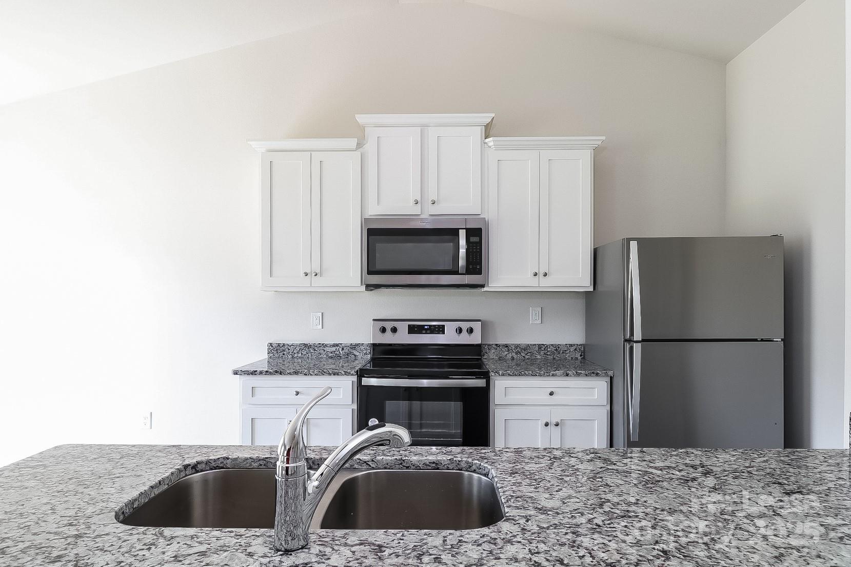 361 Kenyon Drive Kings Mountain, NC 28086 - Photo 5 of 16 a kitchen with a sink stove and refrigerator