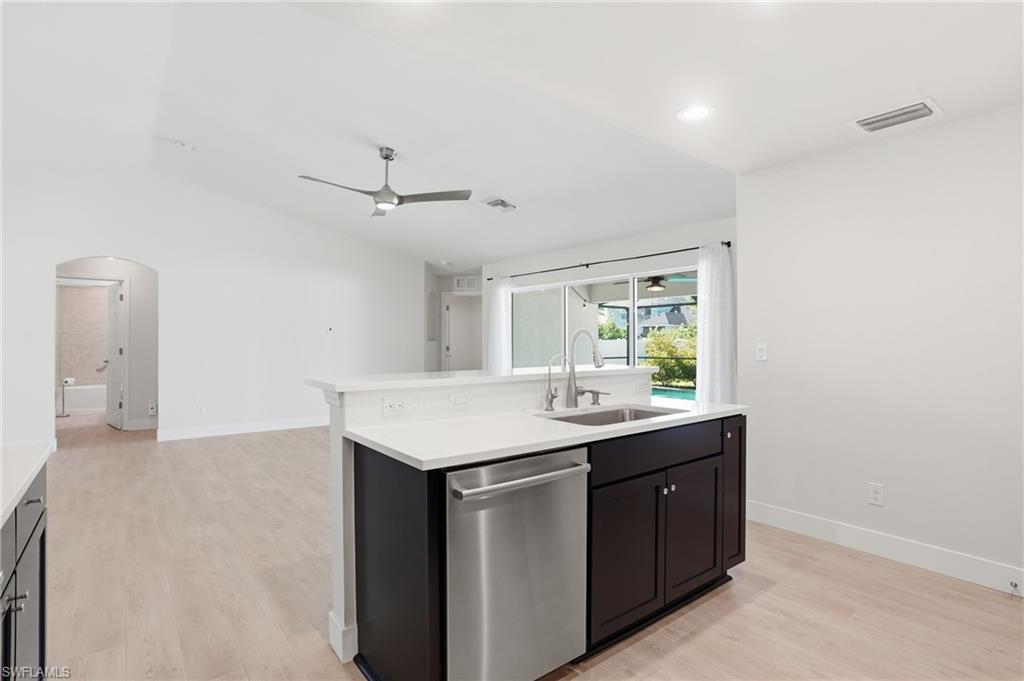 1808 Southwest 30th Street Cape Coral, FL 33914 - Photo 13 of 44 a kitchen with a sink cabinets and a stove