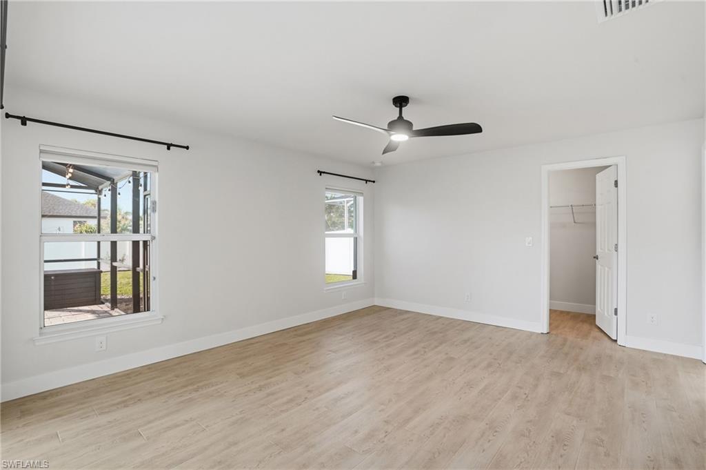 1808 Southwest 30th Street Cape Coral, FL 33914 - Photo 14 of 44 wooden floor in an empty room with a window