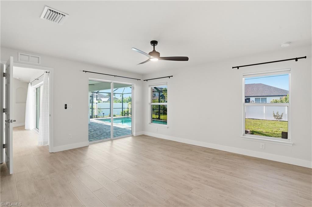 1808 Southwest 30th Street Cape Coral, FL 33914 - Photo 16 of 44 wooden floor in an empty room with a window