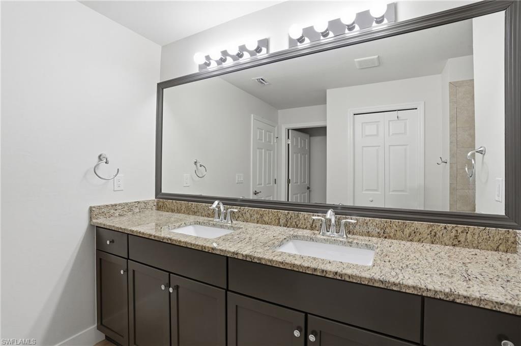 1808 Southwest 30th Street Cape Coral, FL 33914 - Photo 18 of 44 a bathroom with a granite countertop sink double and mirror