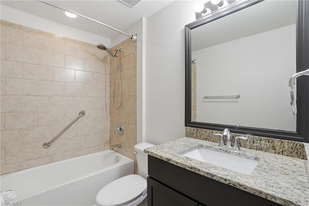 1808 Southwest 30th Street Cape Coral, FL 33914 - Photo 24 of 44 a bathroom with a granite countertop tub sink toilet and mirror