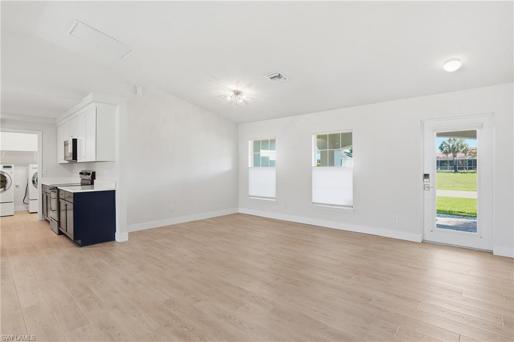 1808 Southwest 30th Street Cape Coral, FL 33914 - Photo 4 of 44 a view of an empty room with a window and wooden floor