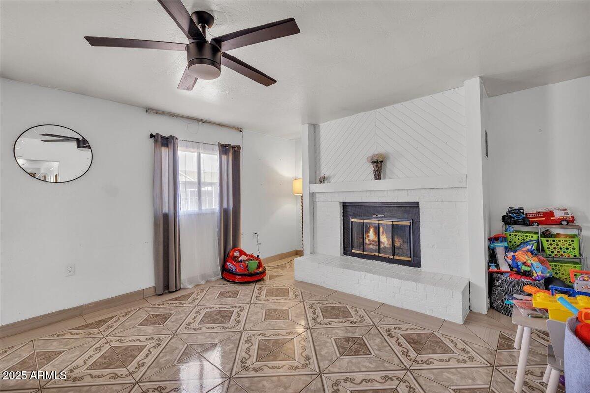 6516 West Cheery Lynn Road Phoenix, AZ 85033 - Photo 14 of 26 a bedroom with a bed and a fireplace
