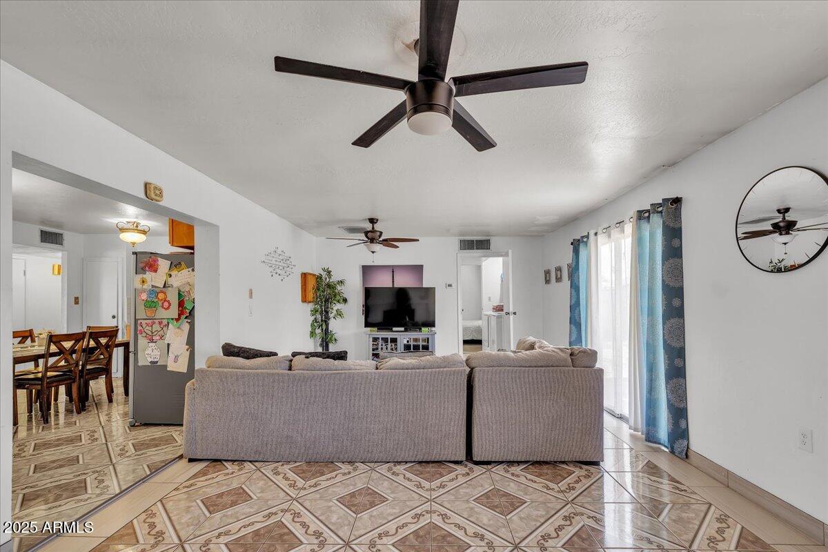 6516 West Cheery Lynn Road Phoenix, AZ 85033 - Photo 15 of 26 a living room with furniture and a flat screen tv