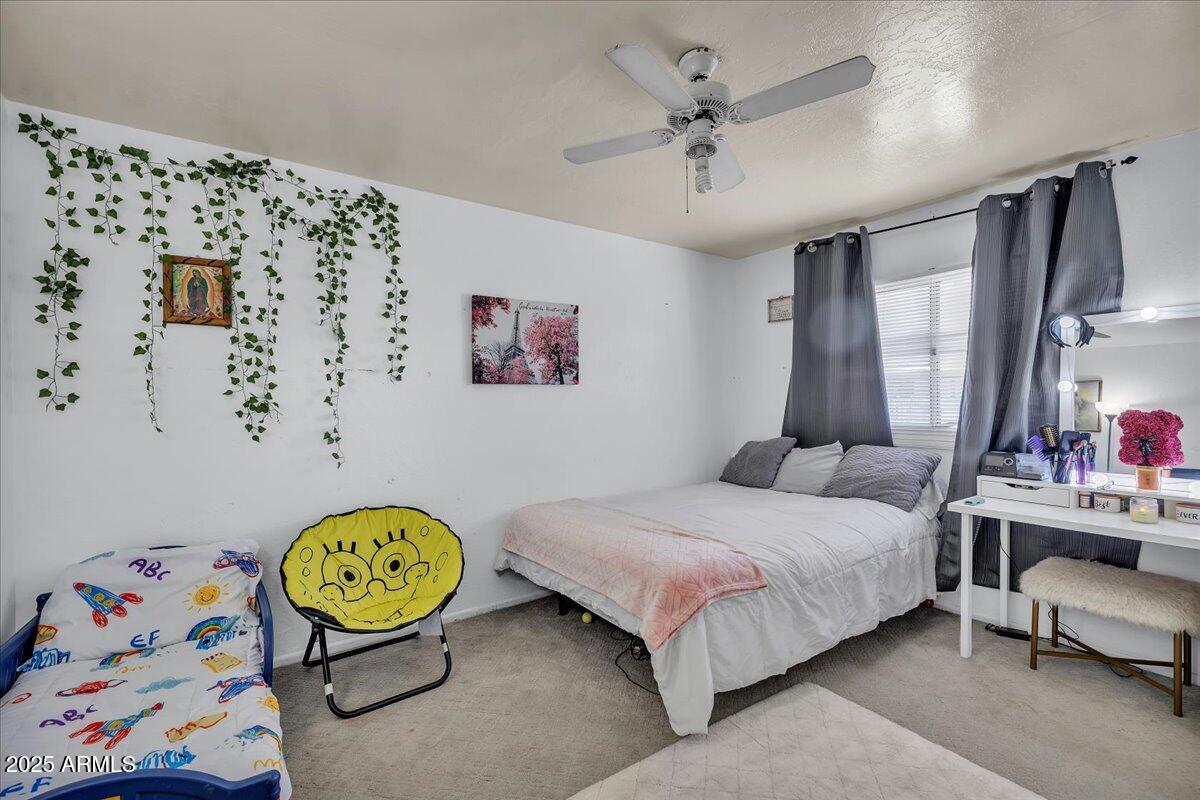 6516 West Cheery Lynn Road Phoenix, AZ 85033 - Photo 22 of 26 a bedroom with a bed dresser and window