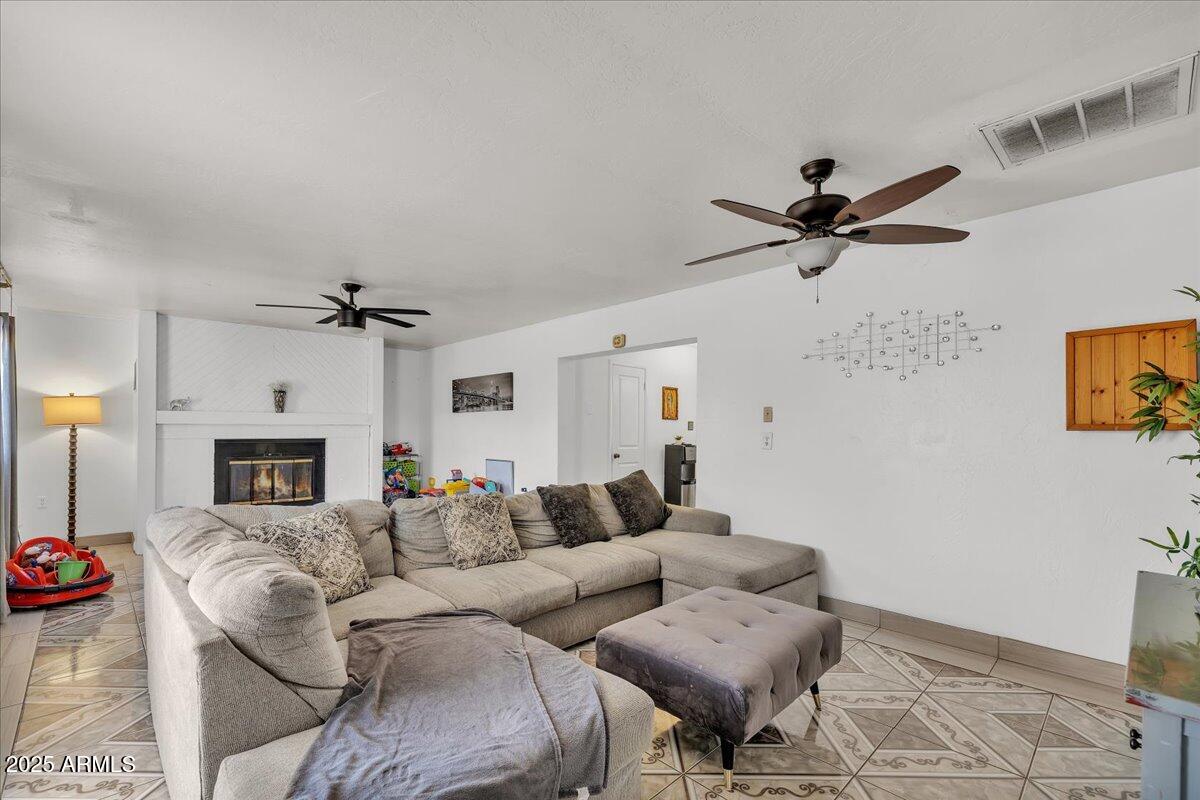 6516 West Cheery Lynn Road Phoenix, AZ 85033 - Photo 25 of 26 a living room with furniture and a fireplace