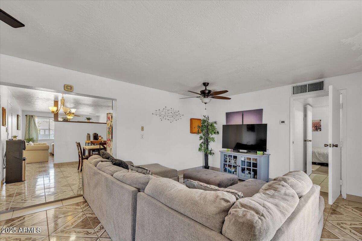 6516 West Cheery Lynn Road Phoenix, AZ 85033 - Photo 26 of 26 a living room with furniture and a flat screen tv