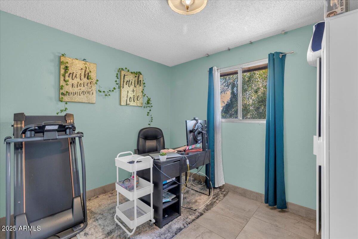 6516 West Cheery Lynn Road Phoenix, AZ 85033 - Photo 7 of 26 a work room with furniture and musical instruments