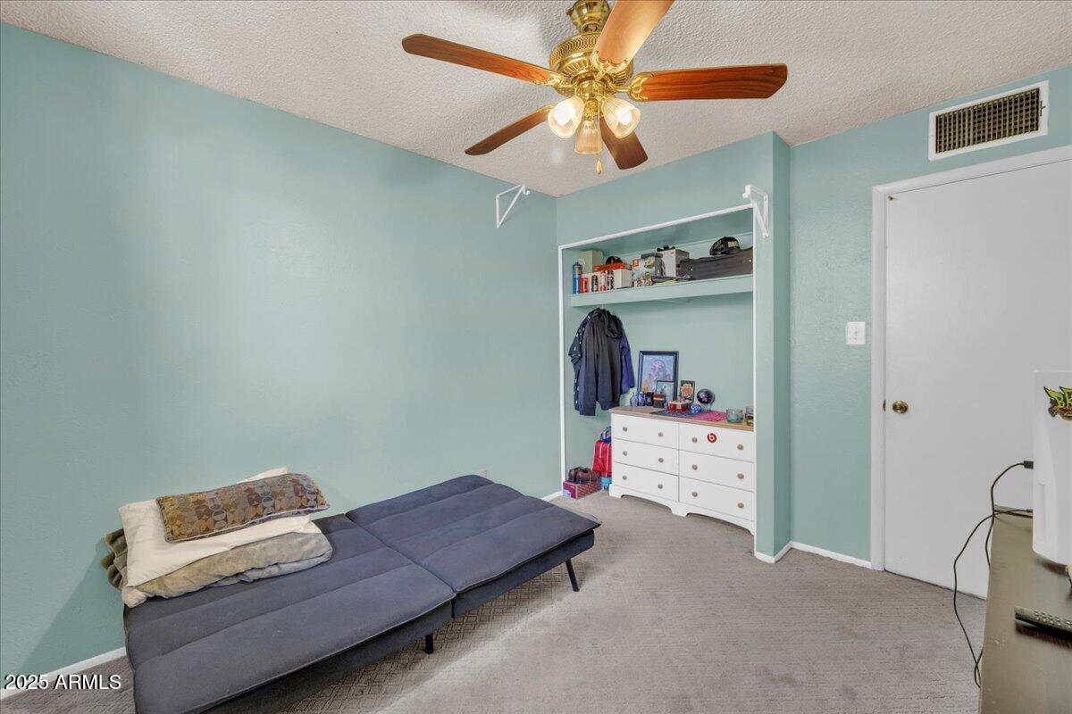 6516 West Cheery Lynn Road Phoenix, AZ 85033 - Photo 10 of 26 a bedroom with furniture and a chandelier fan
