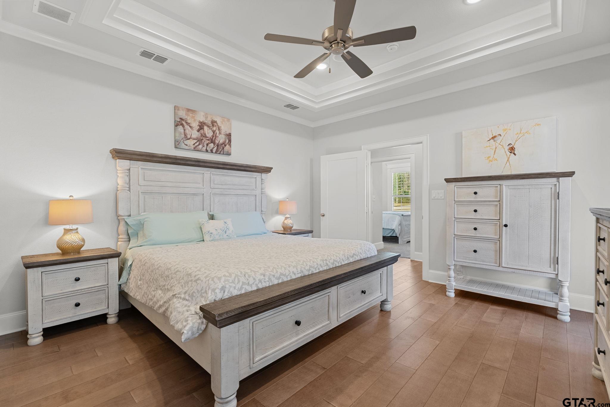 9035 Shallow Cove Tyler, TX 75703 - Photo 11 of 31 a bedroom with a bed and a chandelier