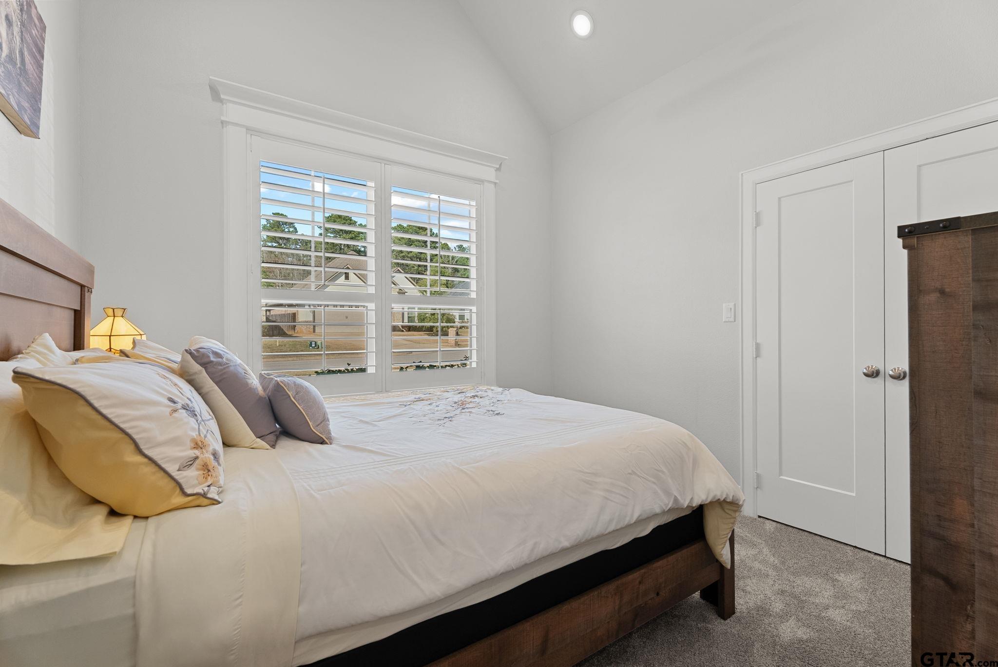 9035 Shallow Cove Tyler, TX 75703 - Photo 18 of 31 a bedroom with a bed and a window