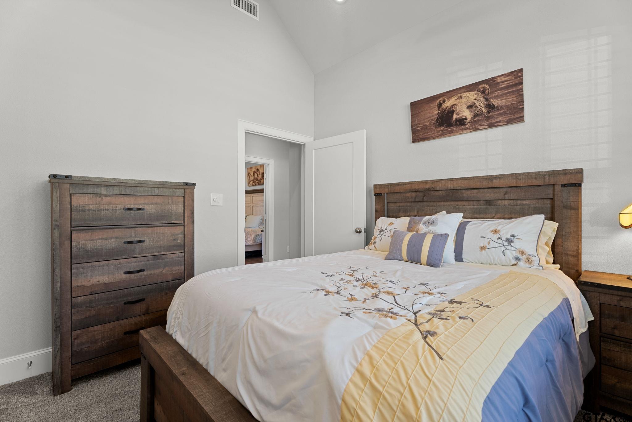 9035 Shallow Cove Tyler, TX 75703 - Photo 19 of 31 a bedroom with a bed and a dresser