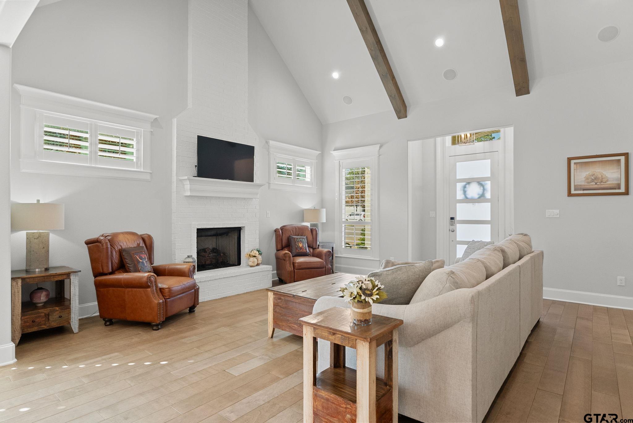 9035 Shallow Cove Tyler, TX 75703 - Photo 3 of 31 a living room with furniture a flat screen tv and a fireplace