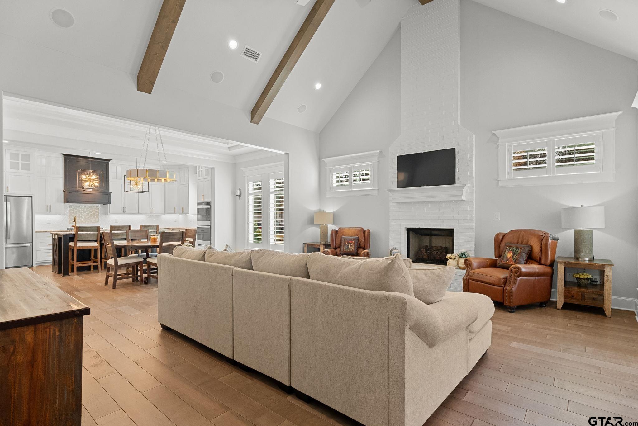 9035 Shallow Cove Tyler, TX 75703 - Photo 4 of 31 a living room with furniture a fireplace and a large window