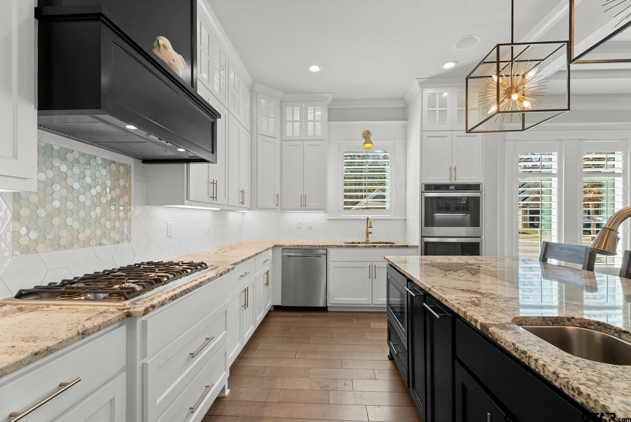 9035 Shallow Cove Tyler, TX 75703 - Photo 10 of 31 a kitchen with a stove sink and cabinets