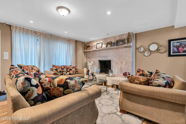 a living room with furniture fireplace and rug