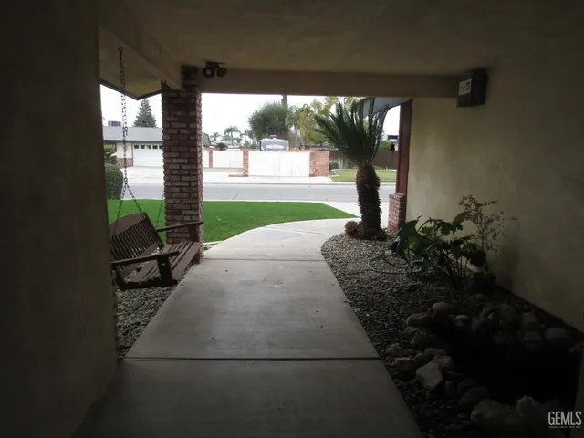 a front view of a house with a garden and porch