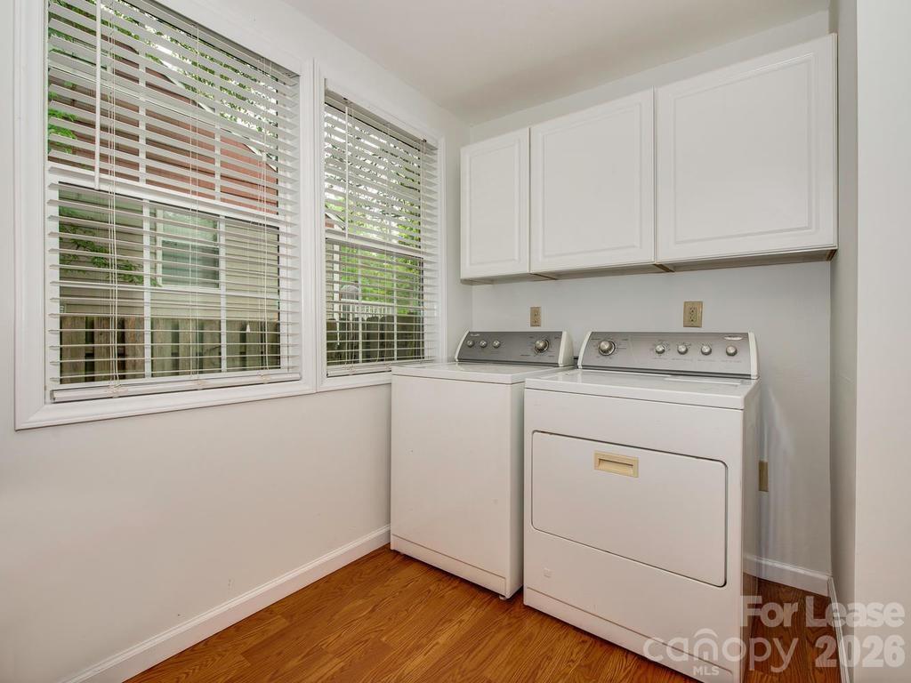 5113 Valley Stream Road Charlotte, NC 28209 - Photo 11 of 17 a utility room with cabinets washer and dryer