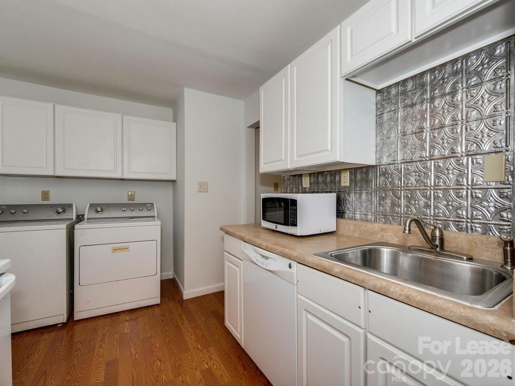 5113 Valley Stream Road Charlotte, NC 28209 - Photo 13 of 17 a kitchen with cabinets appliances a sink and a counter top