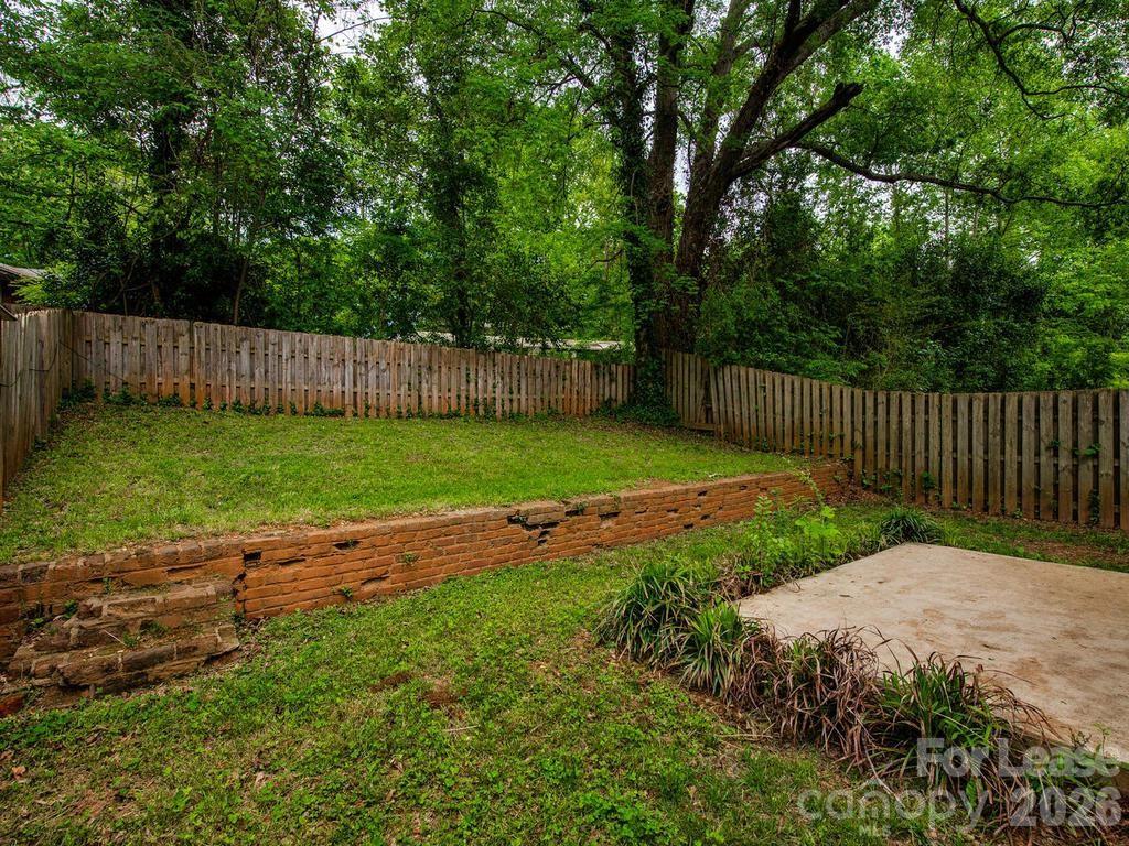 5113 Valley Stream Road Charlotte, NC 28209 - Photo 16 of 17 a view of a backyard with a swing