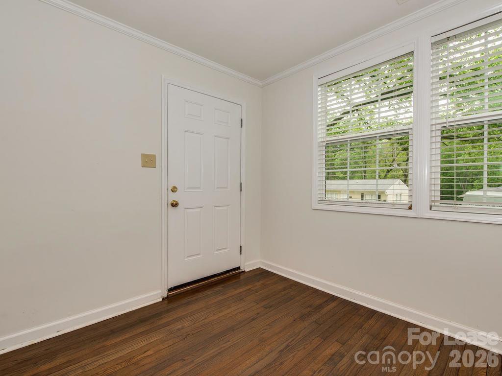 5113 Valley Stream Road Charlotte, NC 28209 - Photo 3 of 17 a view of an empty room with wooden floor and a window