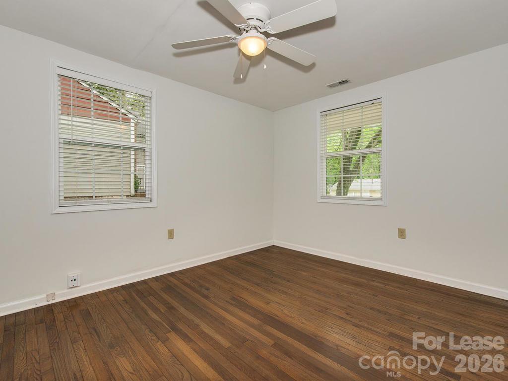 5113 Valley Stream Road Charlotte, NC 28209 - Photo 8 of 17 a view of empty room with wooden floor and fan