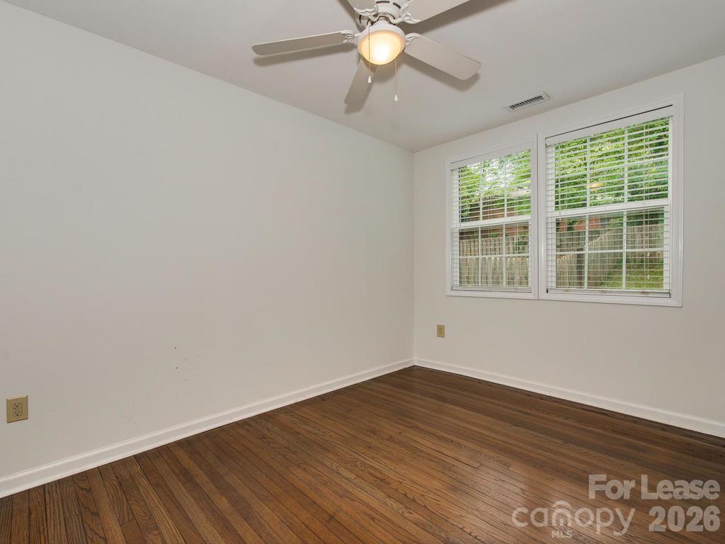 5113 Valley Stream Road Charlotte, NC 28209 - Photo 9 of 17 a view of a room with wooden floor and windows