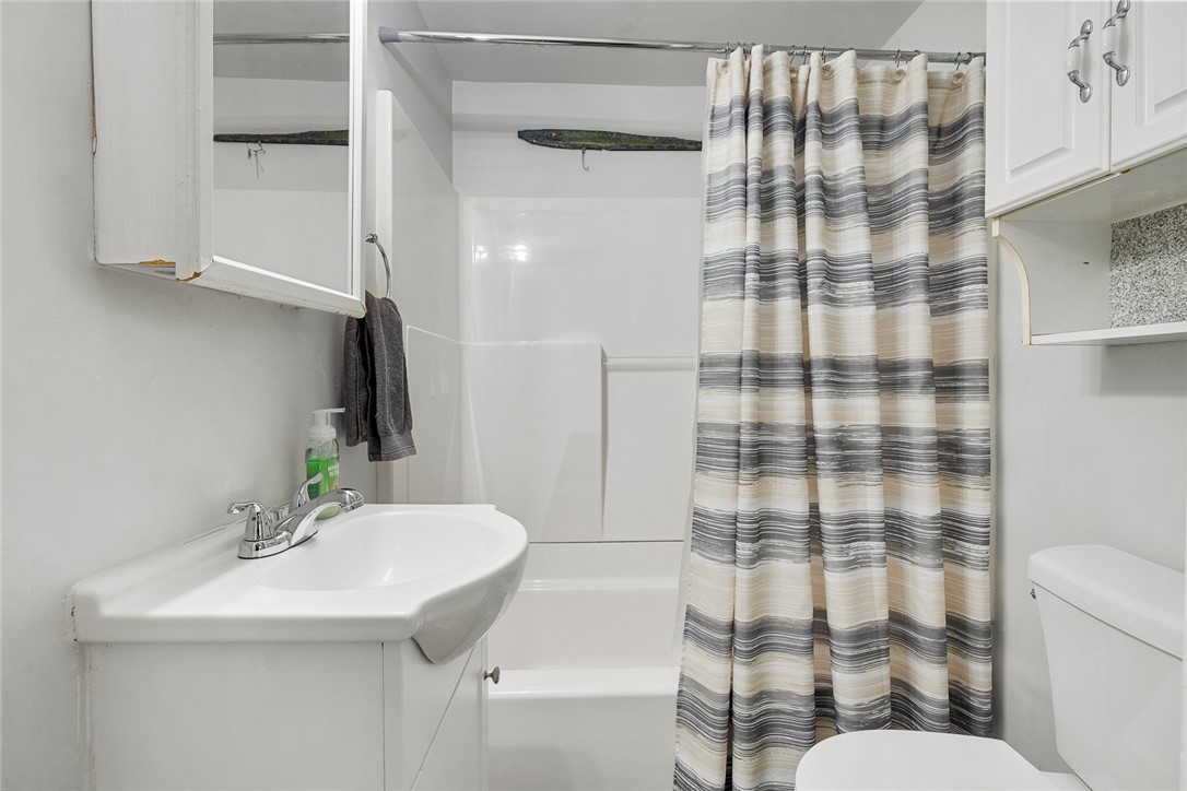 111 State Rd S-4-104 Anderson, SC 29626 - Photo 14 of 42 This bathroom features a sleek vanity and a shower-tub combination, providing a functional design.