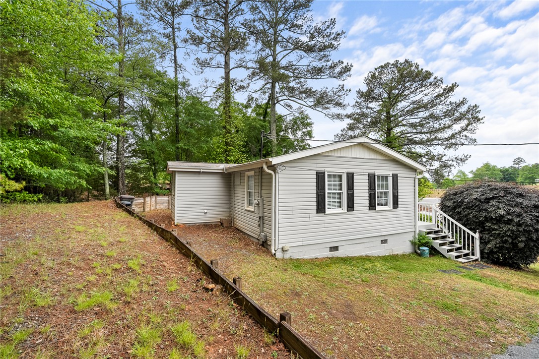 111 State Rd S-4-104 Anderson, SC 29626 - Photo 17 of 42 This charming home offers a serene escape, nestled among lush greenery and mature trees.