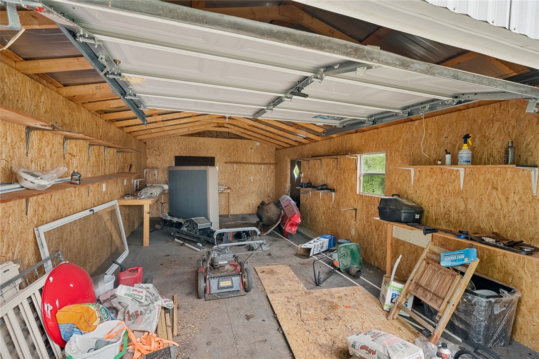 111 State Rd S-4-104 Anderson, SC 29626 - Photo 22 of 42 This spacious roll up garage door garage offers ample storage and workspace, perfect for any project or hobby.