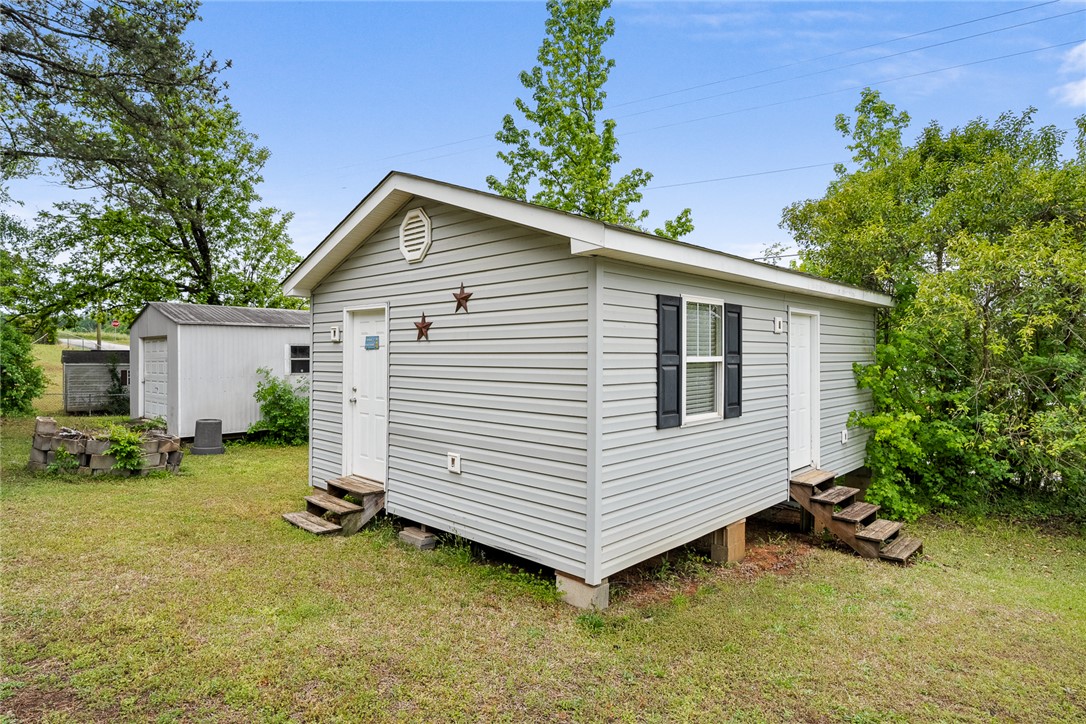 111 State Rd S-4-104 Anderson, SC 29626 - Photo 23 of 42 This quaint shed offers versatile outdoor storage with convenient access in a serene setting.