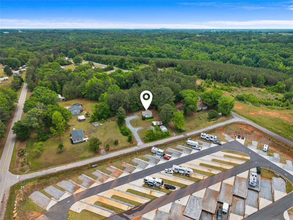 111 State Rd S-4-104 Anderson, SC 29626 - Photo 28 of 42 An aerial view showcases a residential property surrounded by lush greenery and a neighboring recreational vehicle park and lake access!