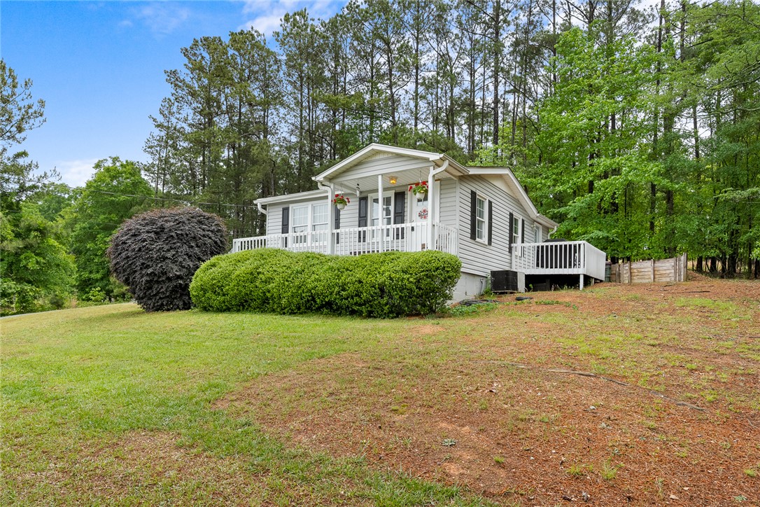111 State Rd S-4-104 Anderson, SC 29626 - Photo 42 of 42 This charming home features a lovely front porch and a spacious yard, surrounded by lush trees.