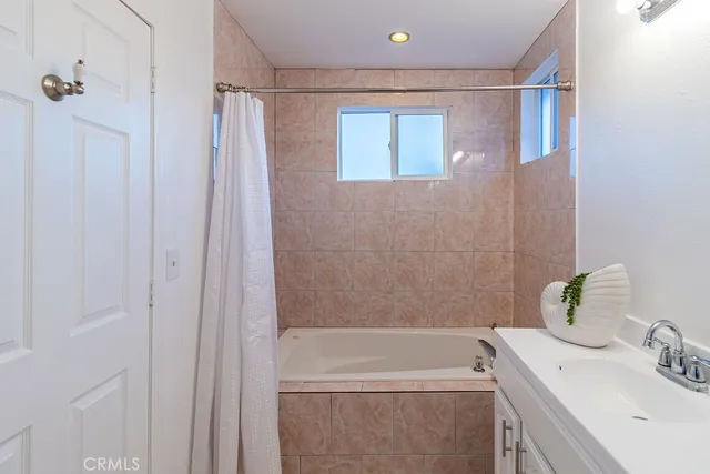 a bathroom with a sink a shower and a bathtub