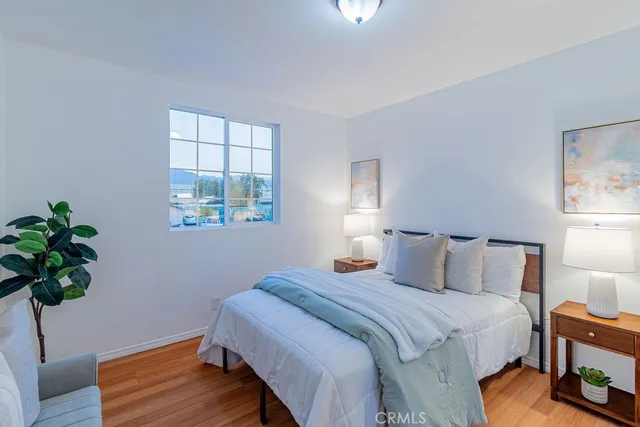 a bedroom with bed window and lamps